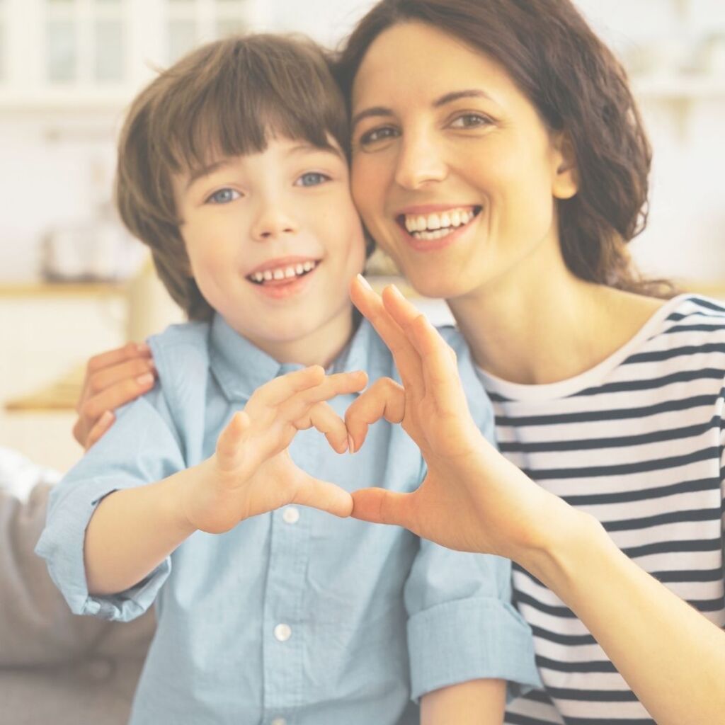 mom and child doing heart signal with hands together for love