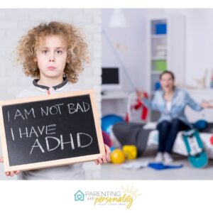 Child holding sign says I am not bad I have ADHD with mother in background