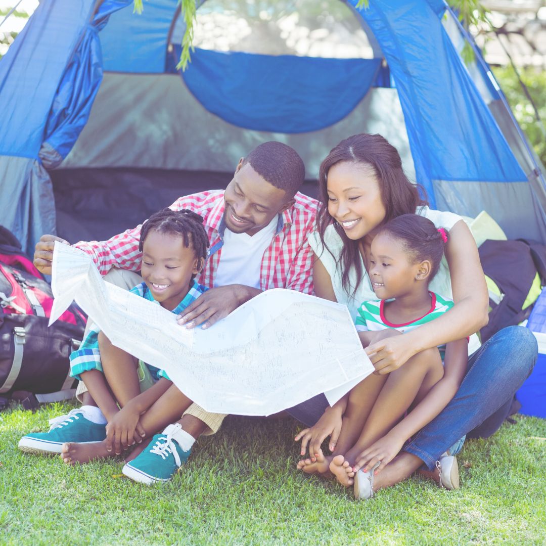 family of four looking at map to decide where to go