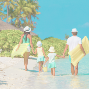 family vacation on the beach walking with inflatables 