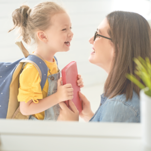mom encouraging an emotional child as she prepares to go back to school