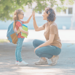 mom high fiving child as her adhd child goes back to school