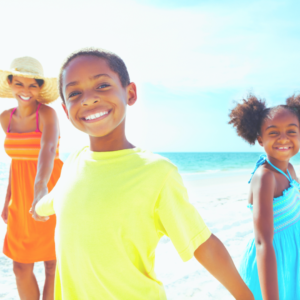 family happy, smiling and holding hands on the beach