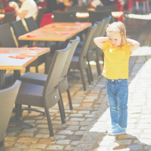 sensory sensitive or highly-sensitive child covering ears at a restaurant