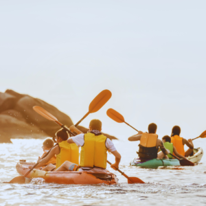 family showing teamwork as they row together on family vacation