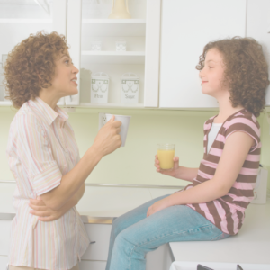 mom and child talking about difficult things as they share a conversation in the kitchen