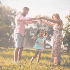 parents working together to help a highly emotional child as they build a bridge with their arms